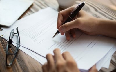 businessman-examining-papers-table